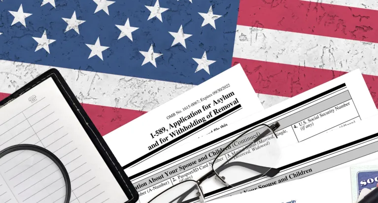 Application for asylum forms and eyeglasses on textured American flag background.